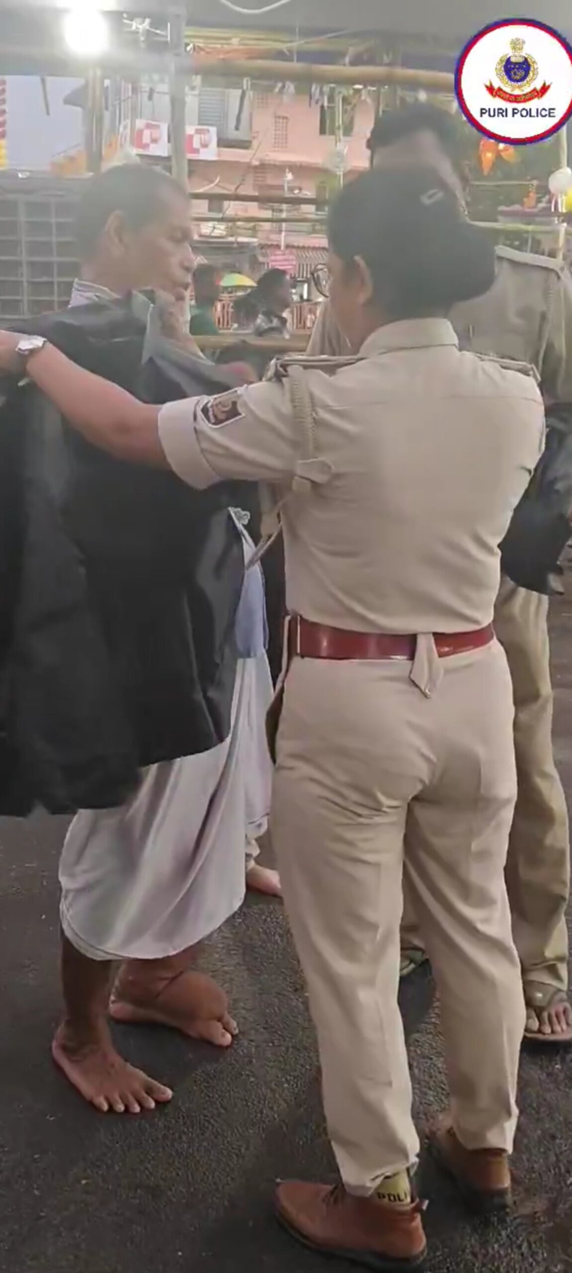 Puri Police Distribute Raincoats to Sanitation Workers and Devotees Amid Heavy Rains During Rath Yatra